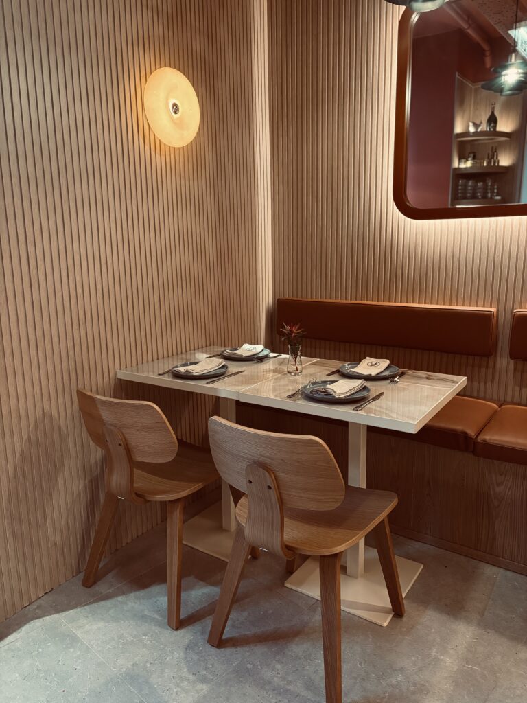 Cozy corner table with wooden walls panels