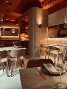 Cozy restaurant atmosphere with natural tons and deep orange color ceiling
