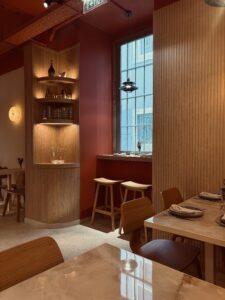 High table facing the window and round corner wooden shelves